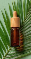 Amber glass dropper bottle atop a palm leaf