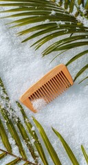 Wooden comb on snow with palm fronds (1)