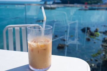 Cocoa drinks and latte coffee on table, beach cafe, sea island background,summer time,rest time holiday.