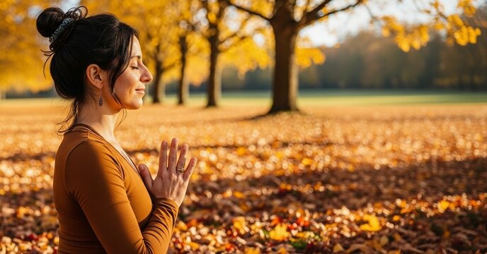 Meditating woman in a sunny autumn park doing yoga pose, serene outdoor scene for wellness and seasonal content