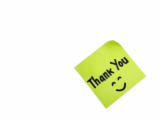 Thank you message on green note paper isolated on white background with smile emoji, Copy space