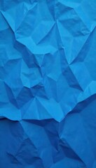 Fototapeta premium Deeply creased blue paper, textured surface, varied shading , blue, wrinkled, abstract