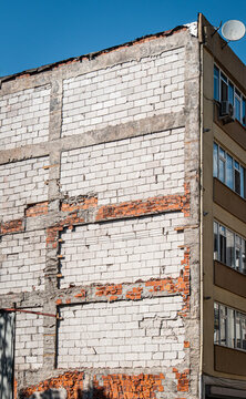 unplastered and unpainted building wall. Demolished building exposed wall.
