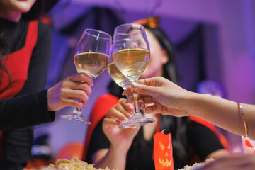 Friends celebrating halloween party making a toast