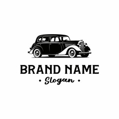 Black and white vintage car logo with brand name and slogan text below it.