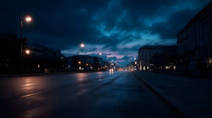 Fototapeta premium A solitary city street at dusk illuminated by streetlights with a dramatic cloudy sky overhead and reflections on the wet pavement