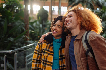 Happy tourist couple visiting train station in madrid