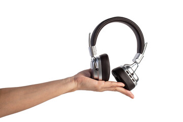 Two-tone silver and brown wireless headphones, Headphones and hand isolate on transparent background. Wireless headphones in brown.