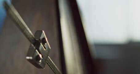 Close Up of Classic Wooden Metronome with Swinging Pendulum, Helping Musicians to Perform Music Accurately. Rhythmic Beats with Tempo to Measure Musical Rhythm. Concept of Time, Practice. Slow Motion.