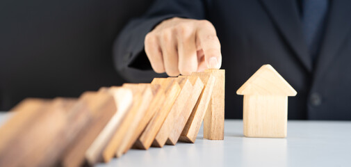 insurance with hands protect domino. Businessman hands stop dominoes falling in business crisis. business risk control and planning and strategies to run prevent insurance businesses.