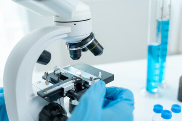 Scientist analyze biochemical samples in advanced scientific laboratory. Medical professional use microscope look microbiological developmental of viral. Biotechnology research in science lab.