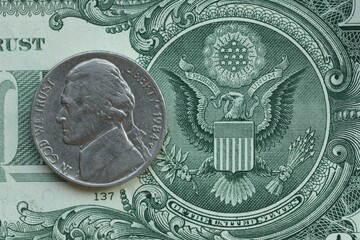 American cent coin on dollar bill close up. United States currency