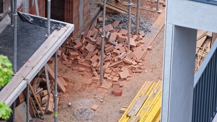 Pile of Red Hollow Cinder Block Brick Leftovers Waste by Unfinished Residential Building Construction Site
