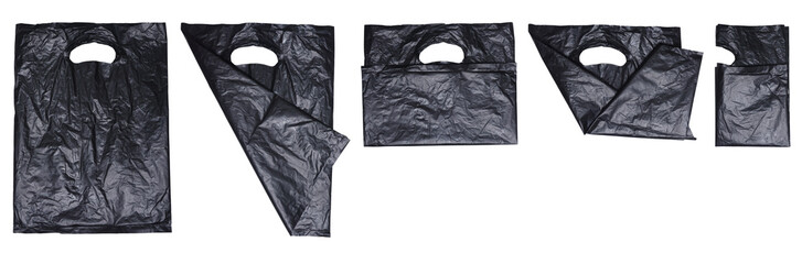 Set collection or collage of folded used black plastic bag with handle isolated on transparent background
