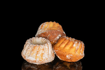 Sweet homemade cupcakes isolated on black background, close-up.