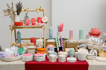 a counter with homemade candles and hand-made decor