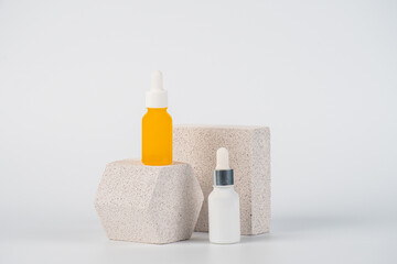Plastic yellow tube for cream or lotion. Skin care or sunscreen cosmetic with stylish props on white background.