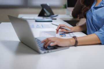Businesswoman analyzing data, working on financial reports