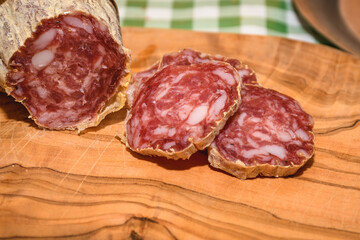 Sliced Salami On A Wooden Plate