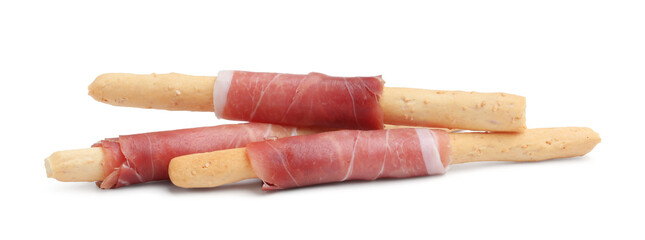 Delicious grissini sticks with prosciutto isolated on white