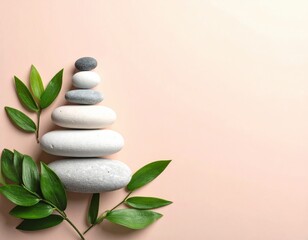 Zen stones and leaves on a soft pink background