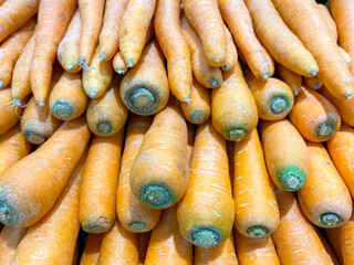 Fresh organic carrots shot from above. Background texture. Stack of carrots in a super market