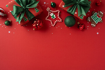 A bright Christmas scene featuring gifts, ornaments, candy cane and gingerbread on a bold red backdrop, creating a joyful holiday mood perfect for seasonal greetings and festive promotion