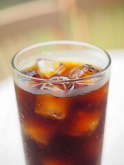 Refreshing iced coffee with ice cubes in a tall glass