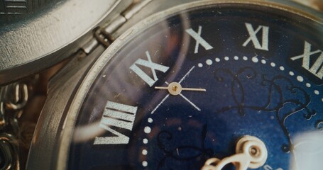 Macro Close Up of Elegant Vintage Pocket Watch with Roman Numerals and Intricate Blue Dial Design....