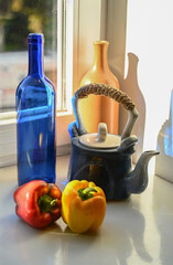 peppers ceramic teapot bottles on the windowsill