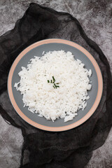 Boiled white rice on gray plate