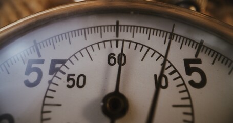Macro Close Up Shot of Mechanical Stopwatch with Metallic Case and Dial with Running Second Hand. Details Symbolizing Sports, Competition, Accuracy, Countdown and Measurement of Athletic Performance.