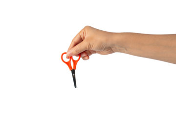 Small orange scissors in hand on transparent background