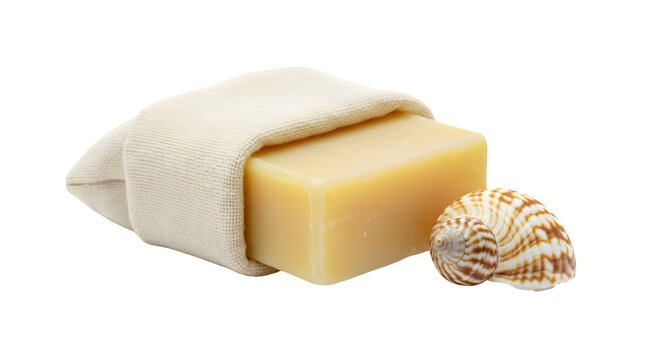 Yellow bar soap sits on a cream cloth next to shells. The minimalist staging works for product photography, cosmetic promotion, and clean social media design.
