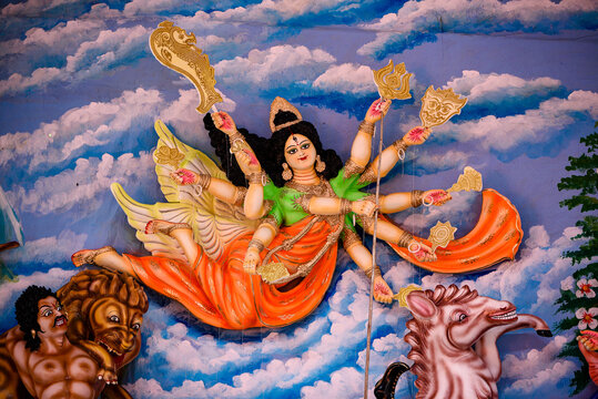 Vibrant Durga Puja Shrine With Goddess Durga And Attendants In Ornate Backdrop