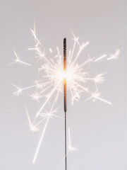 Sparkler burning with bright sparks on soft background