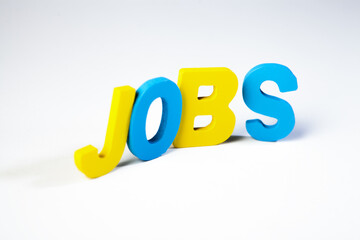 Jobs word made of colorful plastic letters on white background. Job concept.