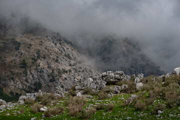 Rocky mountain landscape covered in mist and clouds