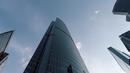 bottom view of the tall skyscrapers of the business district of a modern city