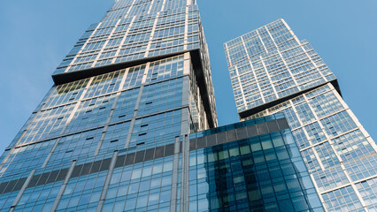 bottom view of the tall skyscrapers of the business district of a modern city