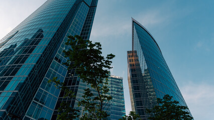 bottom view of the tall skyscrapers of the business district of a modern city