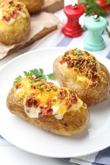 Tasty stuffed baked potatoes on white table, closeup