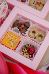 A gift box with handmade teddy bear-shaped chocolates and decorative elements.