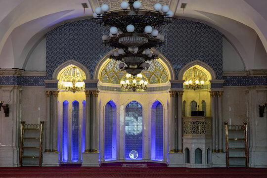 Uruqmi, China - 16 September 2025: View of Erdaoqiao Mosque's prayer hall, where intricate blue tilework meets the warm glow of chandeliers.