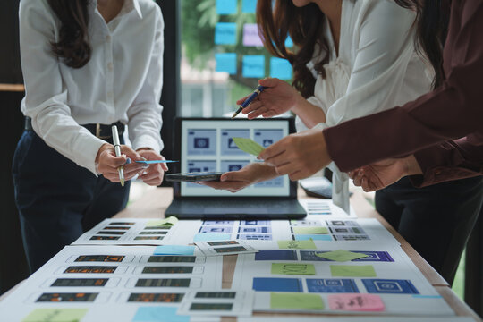 Web designers working on user interface and user experience of mobile application