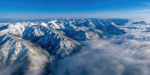 Obraz premium A wide angle landscape of a snowy mountain range towering above a serene valley
