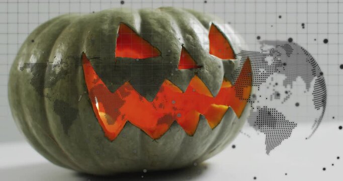 Closeup starting glow flickering on carved pumpkin view shifting dotted map rotating for Halloween