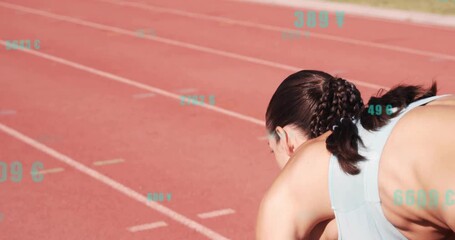 Female athlete bracing at start, driving off blocks on track showing metrics for sports analysis - Powered by Adobe