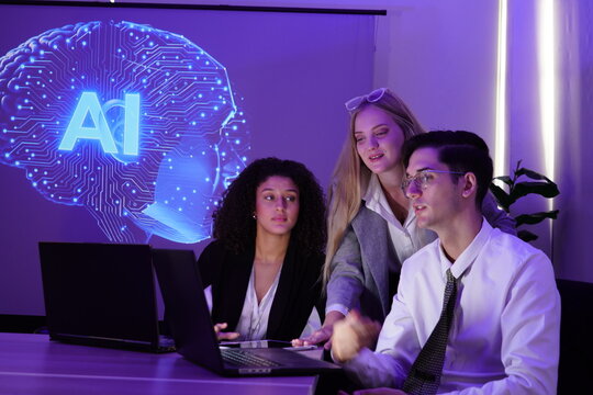 multinational team of one man and two women gathered to brainstorm and discuss their work together. They used computers to present a stock market report using AI charts.