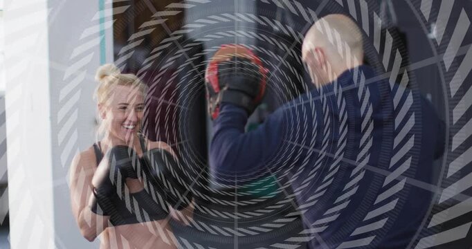 Trainer raising mitts cueing stance, trainee performing jabs or hooks or uppercut or ducking or slid